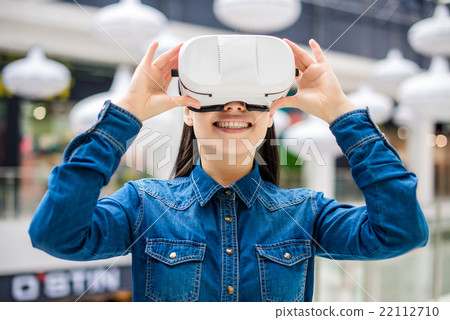 Woman wearing virtual reality glasses Woman wearing virtual reality glasses 22112710