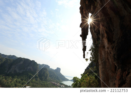 sunrise through the cliff at seaside 22112753