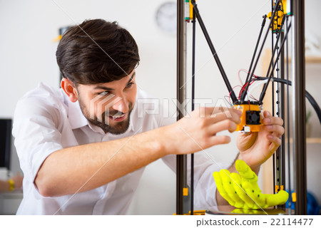 Cheerful man using 3d printer  22114477