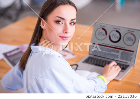 Pleasant woman working on the laptop 22115030