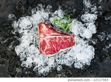 Raw fresh meat t-bone steak on chipped ice with Raw fresh meat t-bone steak on chipped ice with 22117363