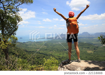 cheering woman hiker open arms at mountain peak cheering woman hiker open arms at mountain peak 22118888
