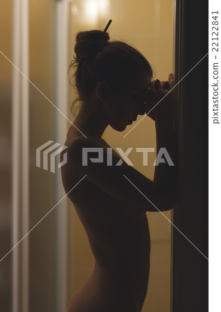 Naked girl in the dark room. 22122841
