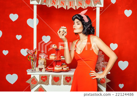 Woman holding a cake. 22124486