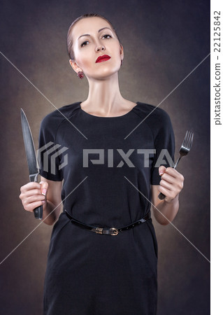Girl with red lips with a fork and knife. Girl with red lips with a fork and knife. 22125842