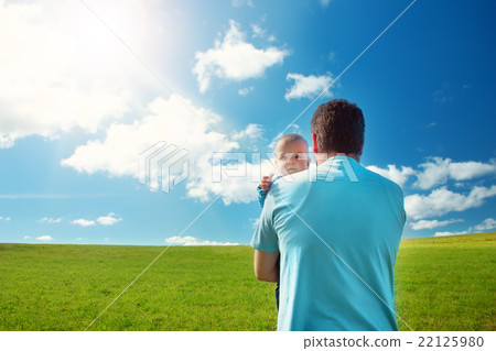 Little baby with father standing in the field Little baby with father standing in the field 22125980