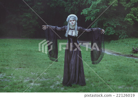 Blond girl with beautiful hair stands in the park. Blond girl with beautiful hair stands in the park. 22126019