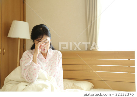 Woman getting up from bed 22132370