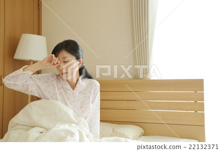 Woman getting up from bed 22132371
