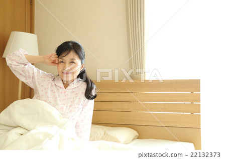Woman getting up from bed 22132373