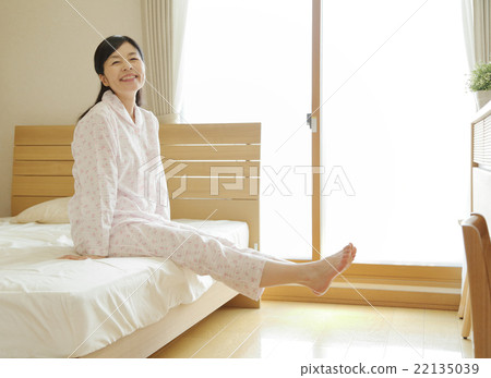 Woman getting up from bed Woman getting up from bed 22135039