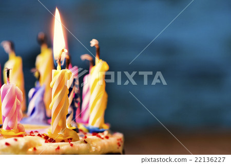 blowing out the candles of a cake 22136227