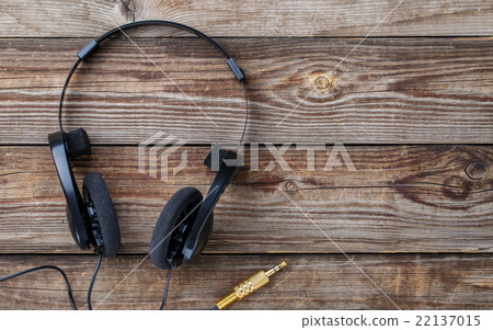 Headphones over wooden table. 22137015
