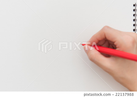 A woman writing with a red pen 22137988