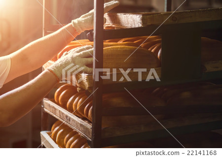 Hand touching shelves with bread. Hand touching shelves with bread. 22141168