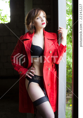 Attractive woman alluring in lingerie and coat. Attractive woman alluring in lingerie and coat. 22141227