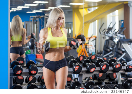 Woman doing a workout with dumbbells  22146547