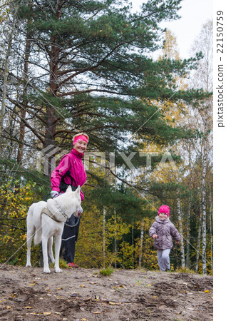 Granny with her granddaughter and a dog walk in Park Granny with her granddaughter and a dog walk in Park 22150759