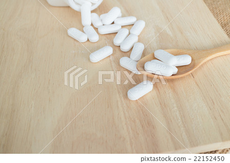many white medicine on wood plate 22152450