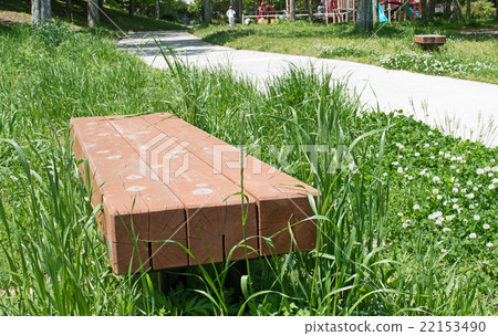 Bench on green grass field in park Bench on green grass field in park 22153490