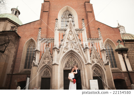 Wedding couple, bride and groom near a church in 22154580