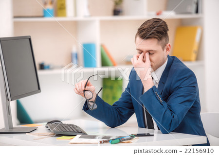 Young businessman working in office Young businessman working in office 22156910