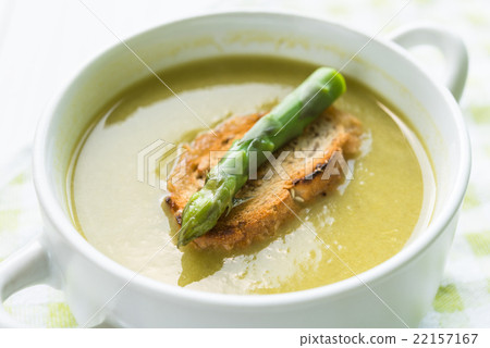 Asparagus soup in a white bowl with slice of bread Asparagus soup in a white bowl with slice of bread 22157167