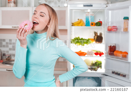 Young blonde at home near fridge Young blonde at home near fridge 22160187