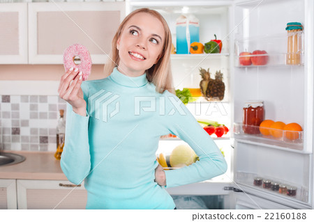 Young blonde at home near fridge Young blonde at home near fridge 22160188