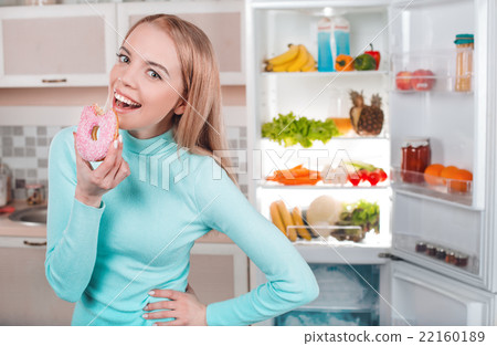 Young blonde at home near fridge Young blonde at home near fridge 22160189