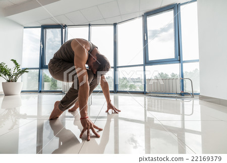 Man training yoga at the gym Man training yoga at the gym 22169379