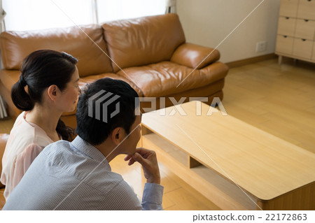 A couple looking at television A couple looking at television 22172863