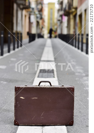 old suitcase in the middle of the street 22173710