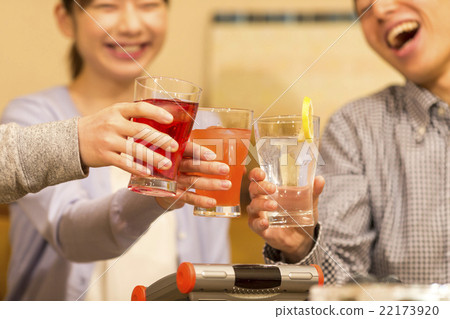 A young Japanese man and a woman toasting with Chu-hi 22173920