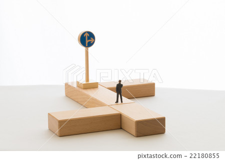 A businessman standing at a branch point 22180855
