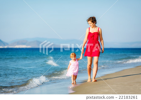 Mother and daughter walking on the beach Mother and daughter walking on the beach 22183261
