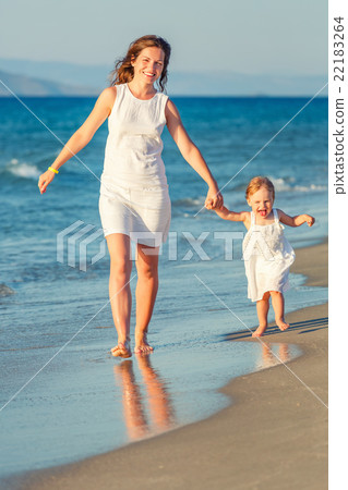Mother and daughter walking on the beach Mother and daughter walking on the beach 22183264