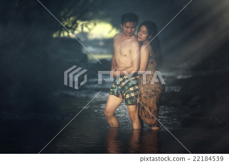 Asian couple bathing at cascade Asian couple bathing at cascade 22184539