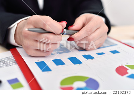 woman holding pen in hand woman holding pen in hand 22192373