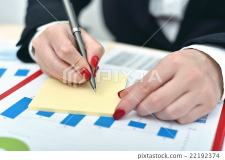 woman taking notes on paper woman taking notes on paper 22192374