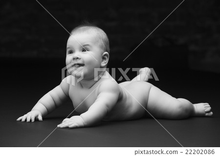 Beautiful baby on a black background Beautiful baby on a black background 22202086
