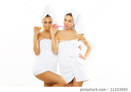 Two girls brush their teeth after shower Two girls brush their teeth after shower 22203985