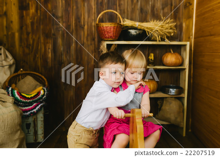 Children riding on a wooden horse Children riding on a wooden horse 22207519