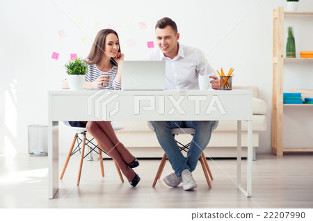 Delighted colleagues working on the laptop Delighted colleagues working on the laptop 22207990
