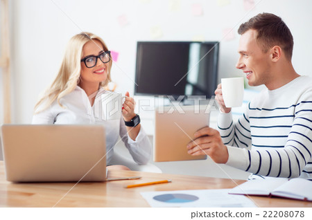 Positive colleagues discussing a project  22208078