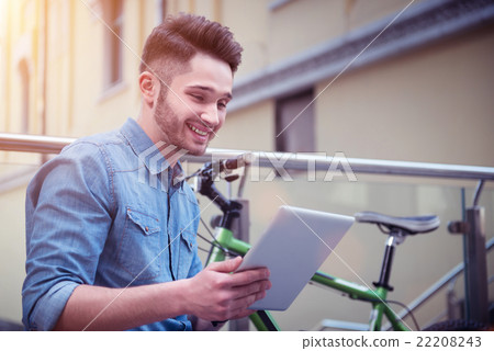 Delighted guy using tablet  22208243