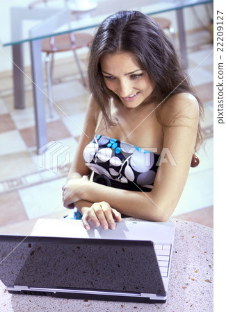 smiling girl in Internet cafe 22209127