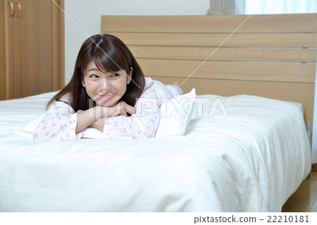 躺在床上的睡衣的一位女士 躺在床上的睡衣的一位女士 22210181