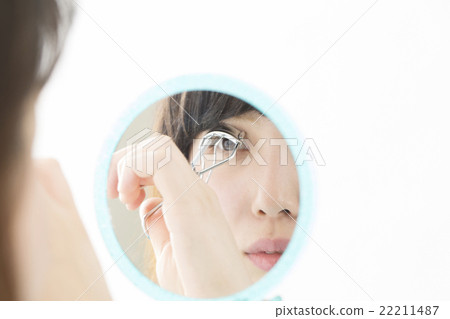 Female Beauty Buffler Makeup Looking at mirror with white back-up copy space 22211487