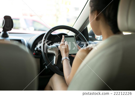 Woman use mobile phone texting while driving 22212226